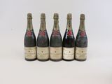 quatre bouteilles de champagne sont alignées sur une surface blanche