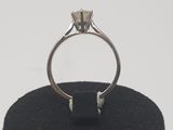 an image of a diamond ring on a black ring stand