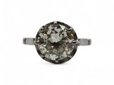 a close up of a diamond ring on a white background