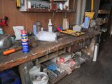 a wooden workbench with tools on it in a garage