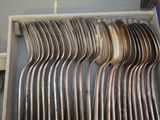 a lot of spoons in a box on the table