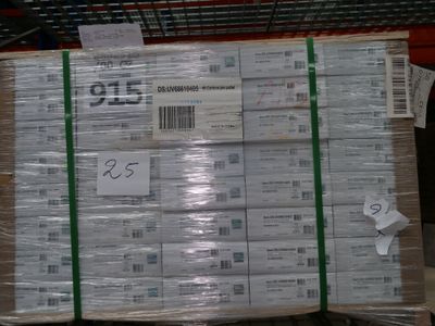 a large stack of packages on a pallet in a warehouse