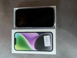 an open box with a black and green phone inside of it