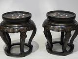 pair of black and gold stools with floral designs on them