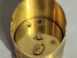 an image of a gold clock on a white surface
