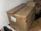 a pile of boxes sitting on the floor in a room