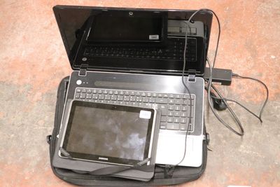 a laptop computer sitting on top of a bag
