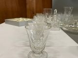 a table with a white table cloth and a glass vase on it