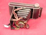 an old camera that is on a pink surface