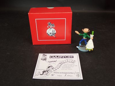 une figurine représentant un homme et une femme sur un skateboard devant une boîte rouge