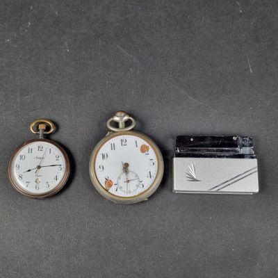 three different types of pocket watches on a table