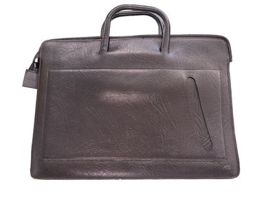 the briefcase is made of brown leather and has a handle