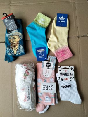 Plusieurs paires de chaussettes sont posées sur une boîte en carton