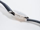 a watch that is sitting on a black strap