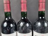 three bottles of wine that are sitting on a table