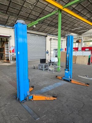 two blue lifts in the middle of a building