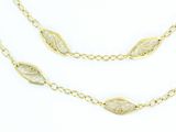 a close up of a gold chain with leaves on it
