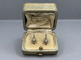 an image of a pair of diamond earrings in a box