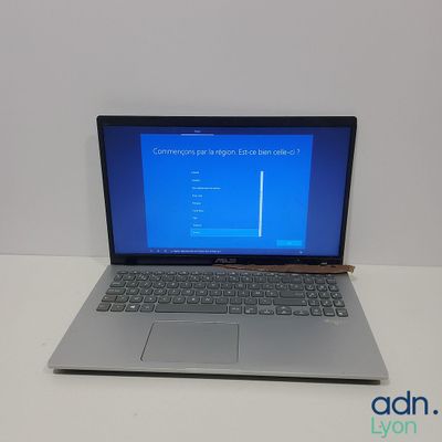 a laptop computer sitting on a table with a blue screen