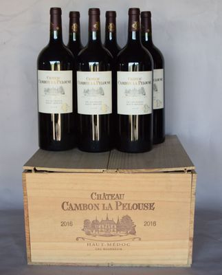 four bottles of wine are in a wooden box on a table