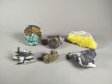 several different types of rocks and stones on a gray surface