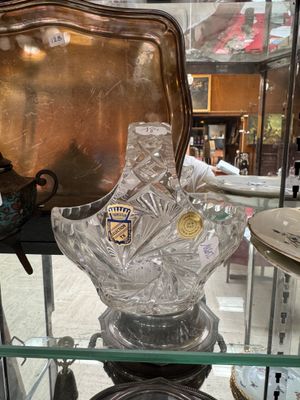 a glass display case with a glass vase on top of it