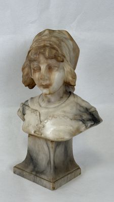 marble bust of a young girl with a hat on her head