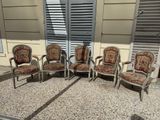 four chairs sitting in front of a window on a patio