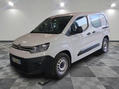 the white van is parked on a checkered floor in a garage