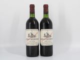 deux bouteilles de vin rouge posées l'une à côté de l'autre sur une surface blanche