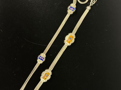 a close up of a pair of silver and blue glass bracelets