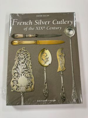 a book with a knife, spoon, and other silverware on it