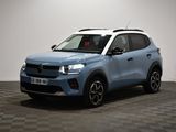 a blue suv parked in a room with a checkered floor