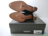 the pair of black shoes are sitting on top of a box