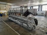 a truck that is parked in a building with a lot of sheets on the back