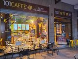 tables and chairs outside of a restaurant with a lot of windows