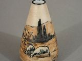 a small vase with a picture of sheep on it