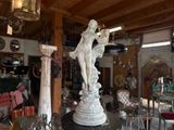 a statue that is sitting on a table in a room