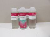 three bottles of hand sanitizer sitting on a counter top