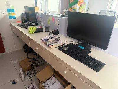 a desk with a computer and a keyboard on it