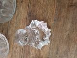 three glass jars sitting on a wooden table