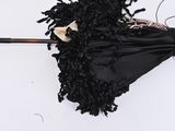 a black umbrella with a black handle on a white surface