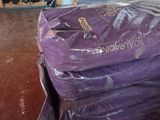 a pile of luggage sitting on a pallet in a store