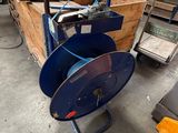 a cart with a blue hose on it in a warehouse