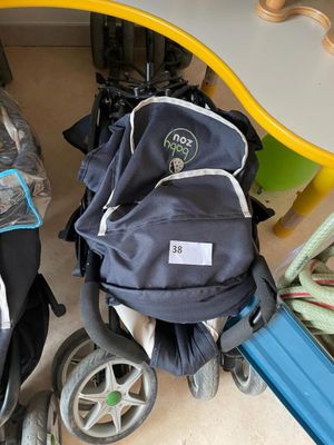 a baby stroller and a stroller with a backpack on it
