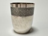 a silver cup that is sitting on a table