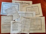 some old papers are sitting on a table with a red table cloth