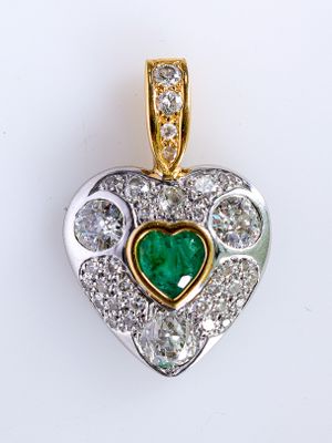 an image of a diamond and emerald heart pendant on a white background
