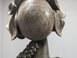 a statue of a woman with a hat on her head