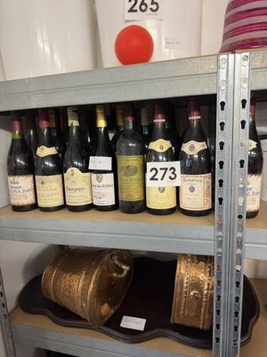 many bottles of wine sitting on a shelf in a store